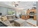 Open-concept living space with cozy couch, ottoman, and seamless transition to the kitchen at 542 Black Lion Ne Dr, St Petersburg, FL 33716