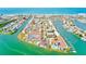 Aerial view of waterfront homes on canals with pools, docks and colorful buildings at 615 Garland Cir, Indian Rocks Beach, FL 33785