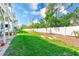 Large grassy backyard enclosed with a white fence, perfect for outdoor activities at 615 Garland Cir, Indian Rocks Beach, FL 33785