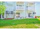 Spacious backyard featuring a well-maintained lawn and private balconies with white lattice at 615 Garland Cir, Indian Rocks Beach, FL 33785