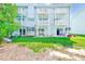 The back of the building has multiple balconies and a well manicured lawn at 615 Garland Cir, Indian Rocks Beach, FL 33785