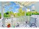 A shady, covered balcony, furnished with chairs, offers a relaxing outdoor living space at 615 Garland Cir, Indian Rocks Beach, FL 33785
