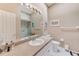 Well-lit bathroom with a modern vanity, neutral walls, a framed mirror, and a glass-enclosed shower at 615 Garland Cir, Indian Rocks Beach, FL 33785