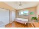 Bright bedroom with natural light features wood floors, twin closets, and a large window with a view at 615 Garland Cir, Indian Rocks Beach, FL 33785