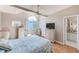 Comfortable bedroom with a fan, wicker furniture, an arched window, and ensuite access at 615 Garland Cir, Indian Rocks Beach, FL 33785