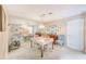 Cozy dining room featuring mirrored wall, a table set for four, and classic wicker chairs at 615 Garland Cir, Indian Rocks Beach, FL 33785