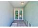Inviting entryway with double glass doors, tiled floor, and views of the outdoors at 615 Garland Cir, Indian Rocks Beach, FL 33785