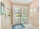 Inviting foyer with glass paneled doors, nautical decor, and a neutral color palette at 615 Garland Cir, Indian Rocks Beach, FL 33785