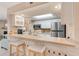 Bright kitchen with white cabinetry, stainless steel appliances, breakfast bar, and a skylight at 615 Garland Cir, Indian Rocks Beach, FL 33785