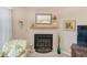 Cozy living room with a fireplace, decorative mirror, and comfortable seating, perfect for relaxation at 615 Garland Cir, Indian Rocks Beach, FL 33785