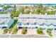 Charming blue townhouse with manicured lawn and a peek of the ocean in the background at 615 Garland Cir, Indian Rocks Beach, FL 33785