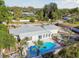 Aerial view showing home with pool and beautiful yard, and the well-maintained landscaping around the property at 6235 Viola Ln, New Port Richey, FL 34653