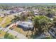 Expansive aerial view of a single-story home with a pool and palm trees at 6235 Viola Ln, New Port Richey, FL 34653
