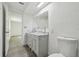 Bathroom featuring double sinks, a marble countertop, and modern fixtures at 6235 Viola Ln, New Port Richey, FL 34653