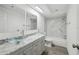 Modern bathroom featuring double glass bowl sinks and marble tile backsplash at 6235 Viola Ln, New Port Richey, FL 34653