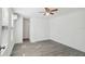 Bright bedroom features light gray flooring, a ceiling fan, and large windows at 6235 Viola Ln, New Port Richey, FL 34653