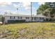 Charming one-story home with a well-maintained lawn and mature landscaping at 6235 Viola Ln, New Port Richey, FL 34653