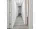 Hallway showcases vinyl plank flooring and neutral paint, seamlessly connecting various spaces at 6235 Viola Ln, New Port Richey, FL 34653