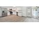 Updated kitchen features stainless appliances, white cabinetry, and a view of the pool area at 6235 Viola Ln, New Port Richey, FL 34653