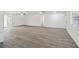 Spacious living room with modern wood flooring and multiple entry points at 6235 Viola Ln, New Port Richey, FL 34653
