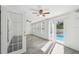 Bright living room featuring pool access and light gray flooring at 6235 Viola Ln, New Port Richey, FL 34653