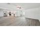 Bright, open-concept living space boasts vinyl floors and a modern kitchen with stainless appliances at 6235 Viola Ln, New Port Richey, FL 34653