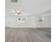 Bright and spacious living room with gray wood floors at 6235 Viola Ln, New Port Richey, FL 34653