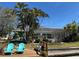Beautiful canal-front backyard featuring lush landscaping, mature trees, and a private dock with comfortable seating at 6319 Cocoa Ln, Apollo Beach, FL 33572
