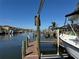 Scenic waterfront dock view with boat lift, showcasing access to open water and a peaceful neighborhood setting at 6319 Cocoa Ln, Apollo Beach, FL 33572