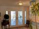 Inviting entryway with decorative front doors and unique wall decor at 6319 Cocoa Ln, Apollo Beach, FL 33572