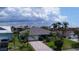 Charming home with a lush, landscaped yard, a paver driveway, and an attached two-car garage at 6319 Cocoa Ln, Apollo Beach, FL 33572
