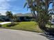 Charming home with a well-manicured lawn, mature trees, and inviting curb appeal in a peaceful neighborhood at 6319 Cocoa Ln, Apollo Beach, FL 33572