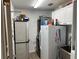 Efficient laundry area with a washer, dryer, cabinets, and utility sink for added convenience at 6319 Cocoa Ln, Apollo Beach, FL 33572