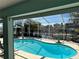 Inviting screened-in pool area perfect for outdoor relaxation and waterfront views, with clear blue water at 6319 Cocoa Ln, Apollo Beach, FL 33572