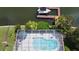 Aerial view of a private, screened-in pool and spa offering a refreshing oasis and outdoor enjoyment on the canal at 6319 Cocoa Ln, Apollo Beach, FL 33572