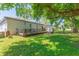 Spacious backyard featuring a deck, outdoor kitchen, and grassy area at 6426 31St S St, St Petersburg, FL 33712