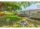 Home's backyard featuring a grassy area, fire pit, deck, and outdoor kitchen at 6426 31St S St, St Petersburg, FL 33712
