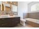 This bathroom features a dark wood vanity with double sinks and a separate bathtub with tile surround at 6426 31St S St, St Petersburg, FL 33712