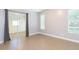 This bedroom features light ceramic tile flooring, two windows and a sliding glass door with curtains at 6426 31St S St, St Petersburg, FL 33712