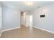 This bedroom features light ceramic tile flooring, an installed TV mount, and multiple doorways at 6426 31St S St, St Petersburg, FL 33712