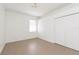 This bedroom features light ceramic tile flooring, a window, overhead lighting, and a closet at 6426 31St S St, St Petersburg, FL 33712