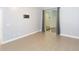 This bedroom features light ceramic tile flooring, sliding glass doors with curtains and an installed TV mount at 6426 31St S St, St Petersburg, FL 33712
