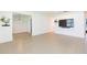 Open-concept living room with tile flooring and a modern wall-mounted television at 6426 31St S St, St Petersburg, FL 33712