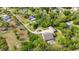 Aerial view of the home showcasing its secluded location surrounded by lush greenery and mature trees at 6448 Country Club Rd, Wesley Chapel, FL 33544
