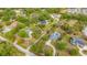 Aerial shot of properties with verdant trees, winding roads, and lush green landscapes at 6448 Country Club Rd, Wesley Chapel, FL 33544