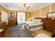 Comfortable bedroom featuring wood floors, natural light, neutral walls and classic furnishings at 6448 Country Club Rd, Wesley Chapel, FL 33544