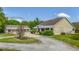 Landscaped front yard with a circular drive, and a detached garage at 6448 Country Club Rd, Wesley Chapel, FL 33544