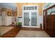 Welcoming foyer with hardwood floors, decorative doors, stylish accents, and plenty of natural light at 6448 Country Club Rd, Wesley Chapel, FL 33544