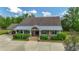 Inviting single-story home with a covered porch and meticulously maintained landscaping at 6448 Country Club Rd, Wesley Chapel, FL 33544