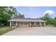 Large detached garage with space for multiple cars and a metal roof at 6448 Country Club Rd, Wesley Chapel, FL 33544